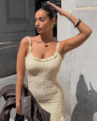 Cream dress with ruffled straps, close-up view